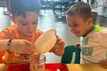 Kiddos pouring slime activator