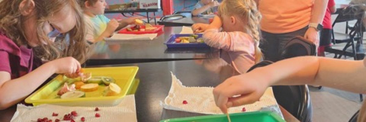 Children doing STEAM by looking for seeds from produce